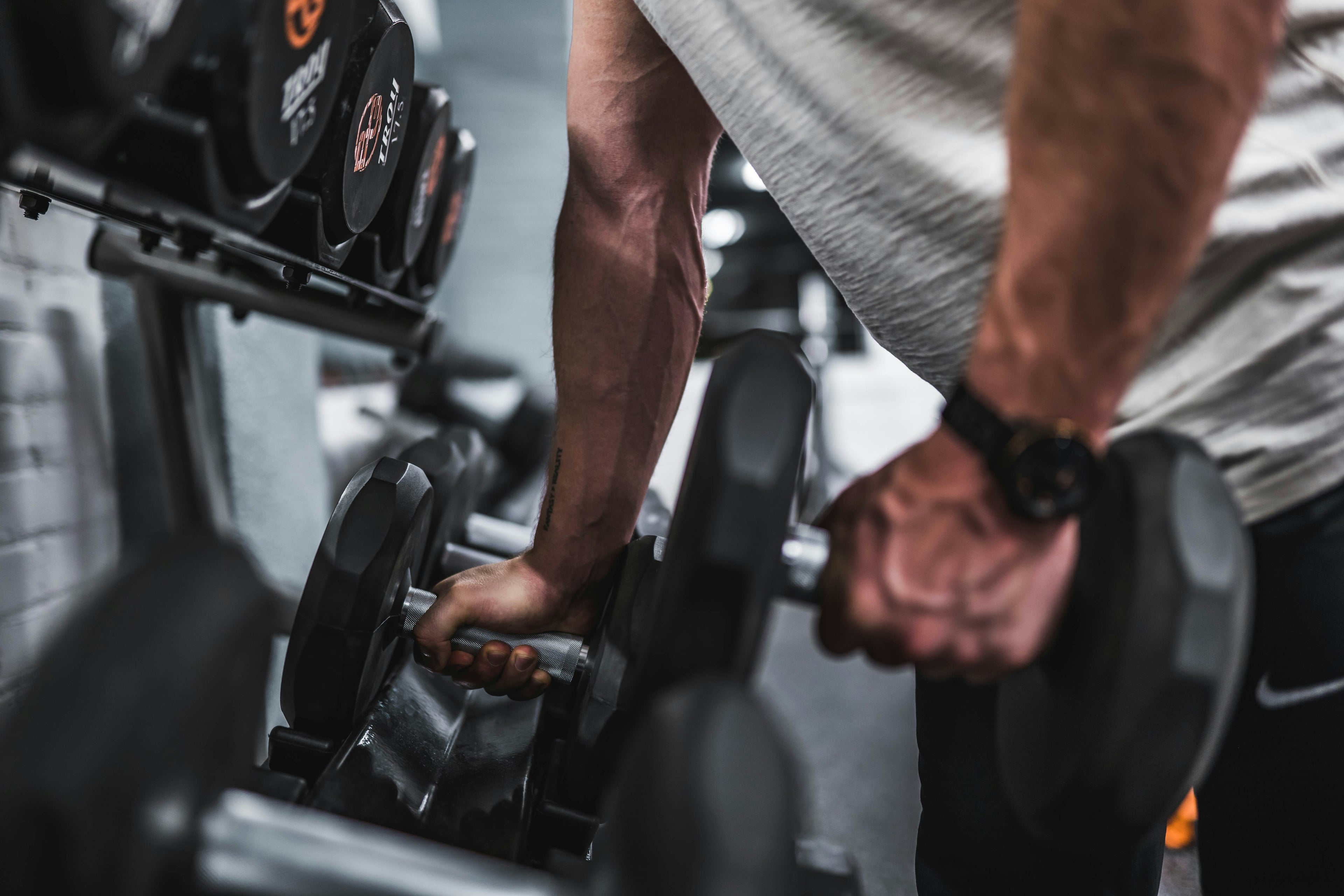Person using a rowing machine in a gym setting