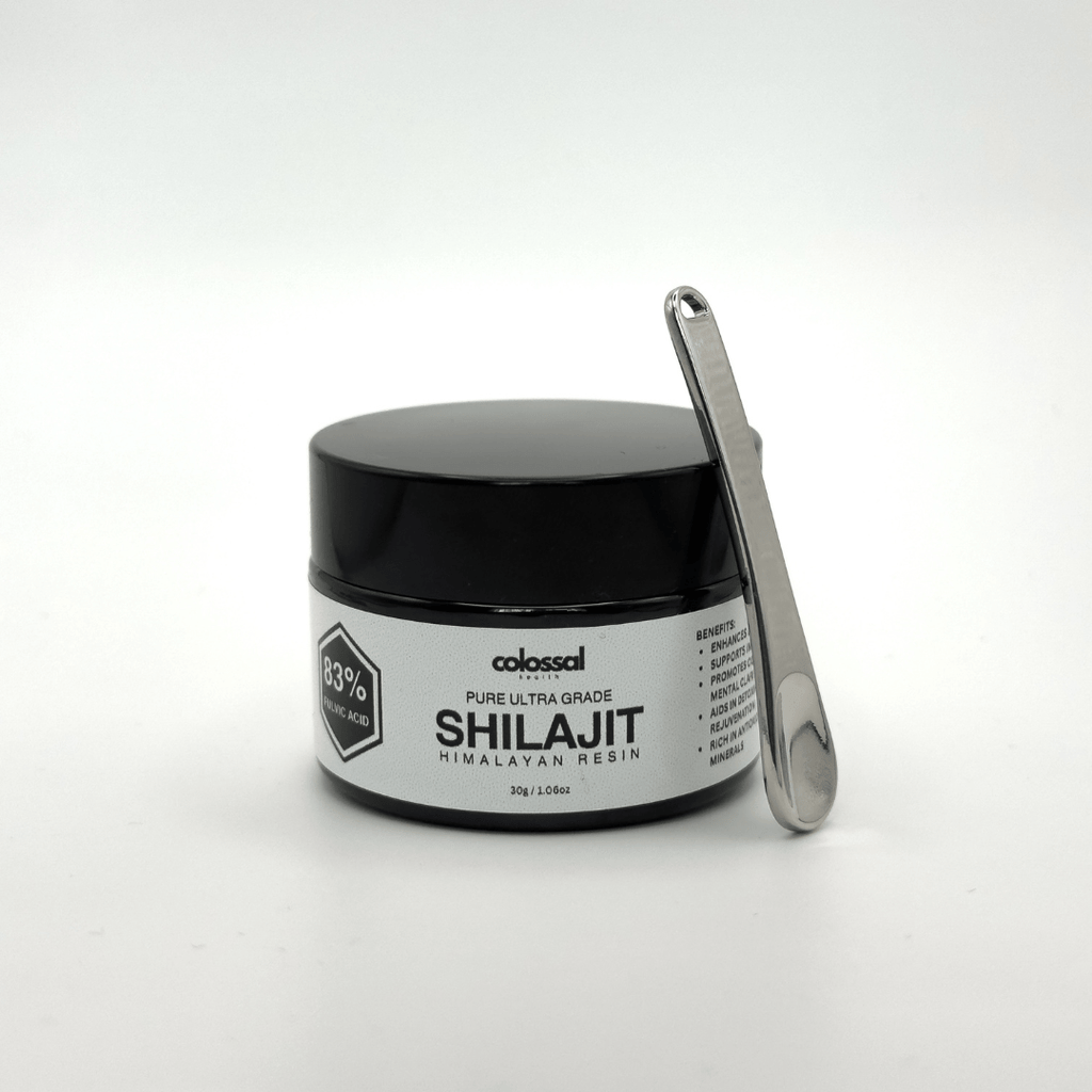 Jar of Pure Ultra Grade Shilajit from Colossal Health with a metal scoop on a white background