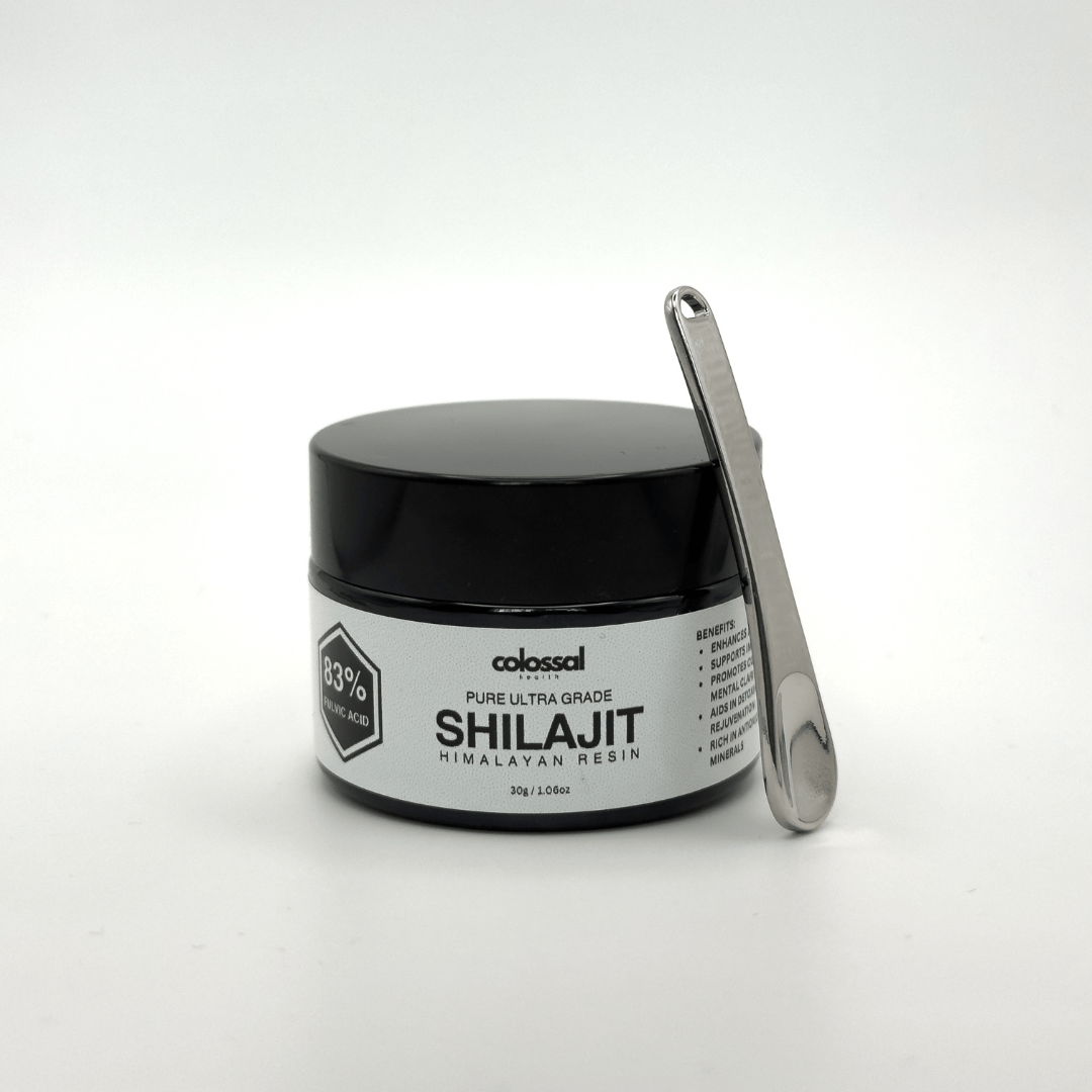 Jar of Pure Ultra Grade Shilajit from Colossal Health with a metal scoop on a white background